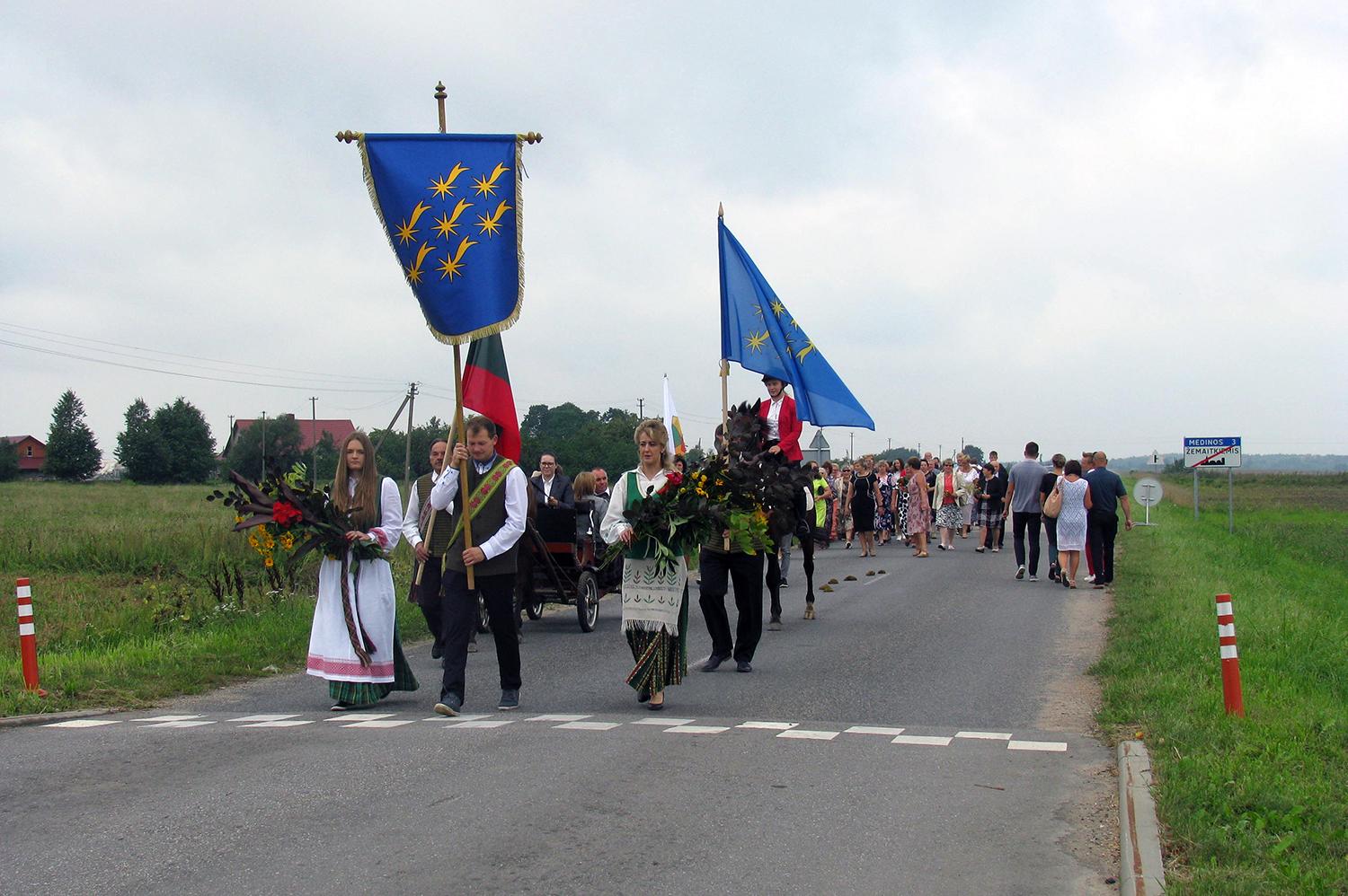 Minint miestelio jubiliejų – tradicinė Žolinės šventė / Eisenoje iškilmingai nešta miestelio vėliava. Arvydo Mikučio nuotr.